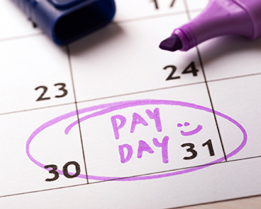 Calendar with pay day written in purple marker and circled