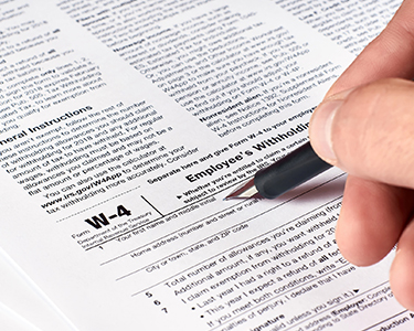 Man filling out W-4 form