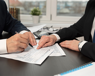 Two men filling out tax paperwork