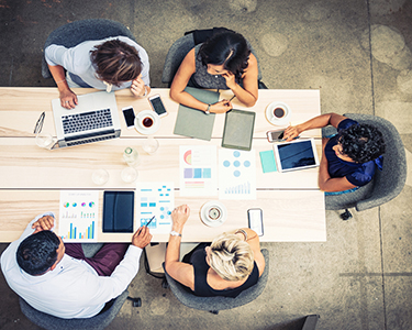 Small business financial team meeting around table