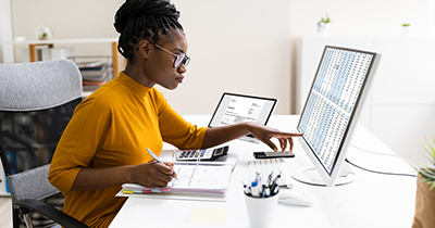 Woman looking at spreadsheets on a computer