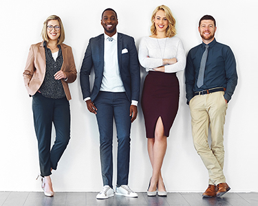 Business professionals leaning against a wall